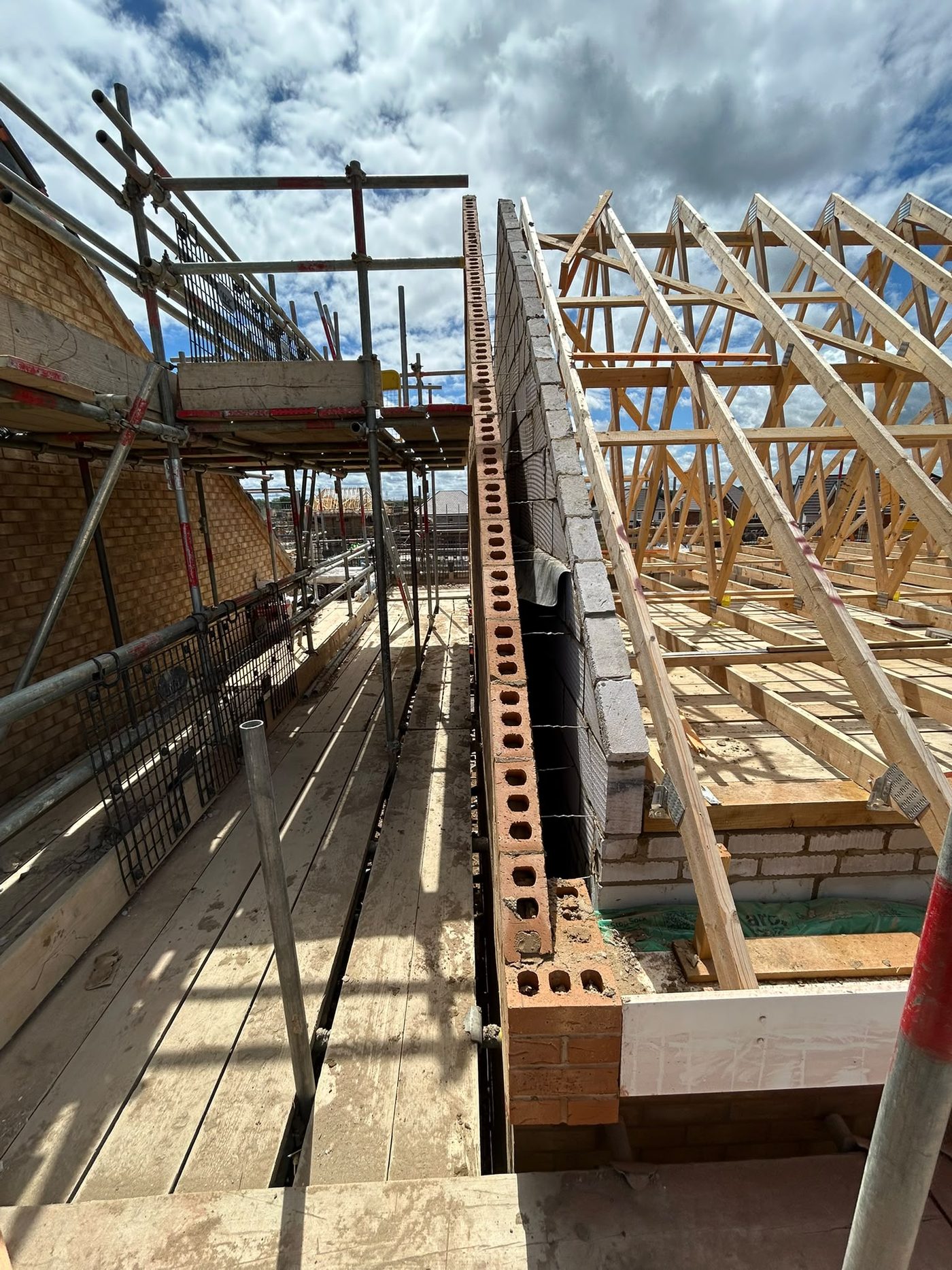 Roof trusses going on above the scaffold
