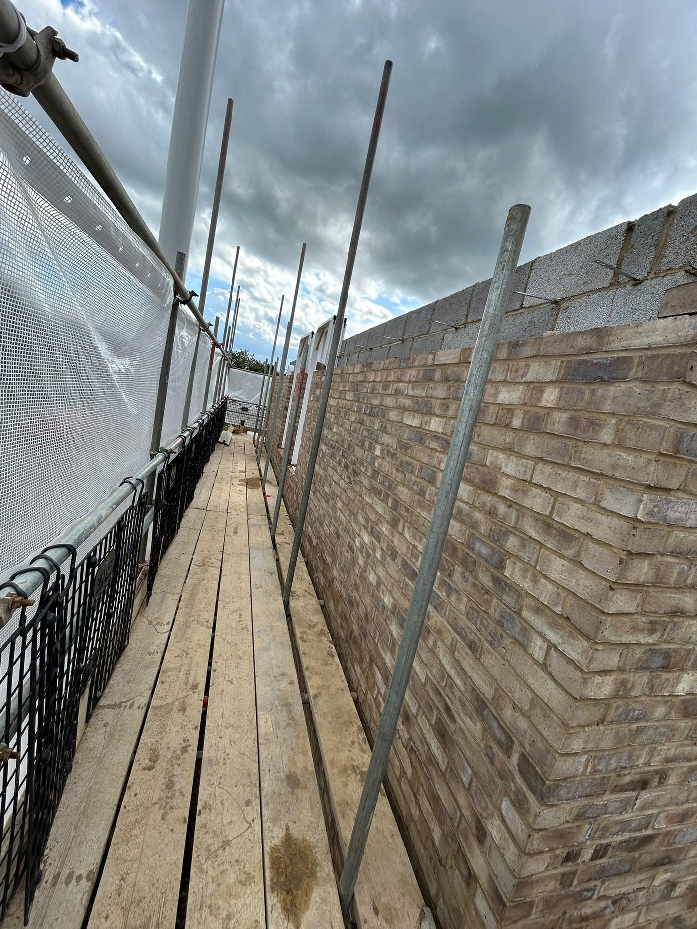 Facing brickwork behind the scaffold
